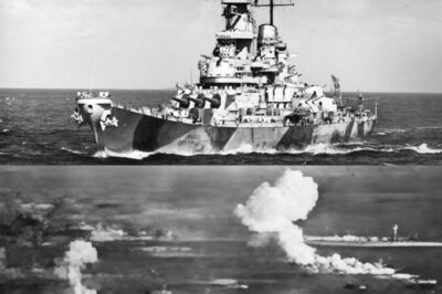 THE DAY A U.S. BATTLESHIP FIRED BEYOND THE HORIZON — February 17, 1944. Truk Lagoon is choking under smoke and heat, and the Pacific looks almost calm from a distance—until you realize how many ships are burning behind that haze.